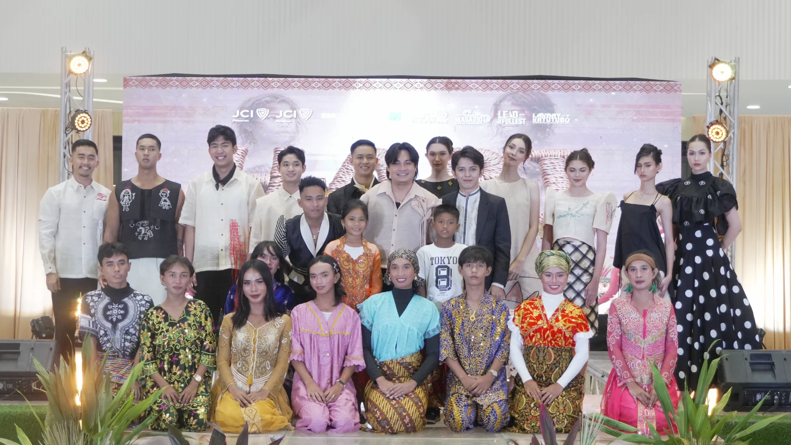 ABOVE: Designer Mike Yapching poses with Project Chairs Macvy Gaviola and Tristan Maraon together with the models, the Badjao LGBT queens and some of the children artists.